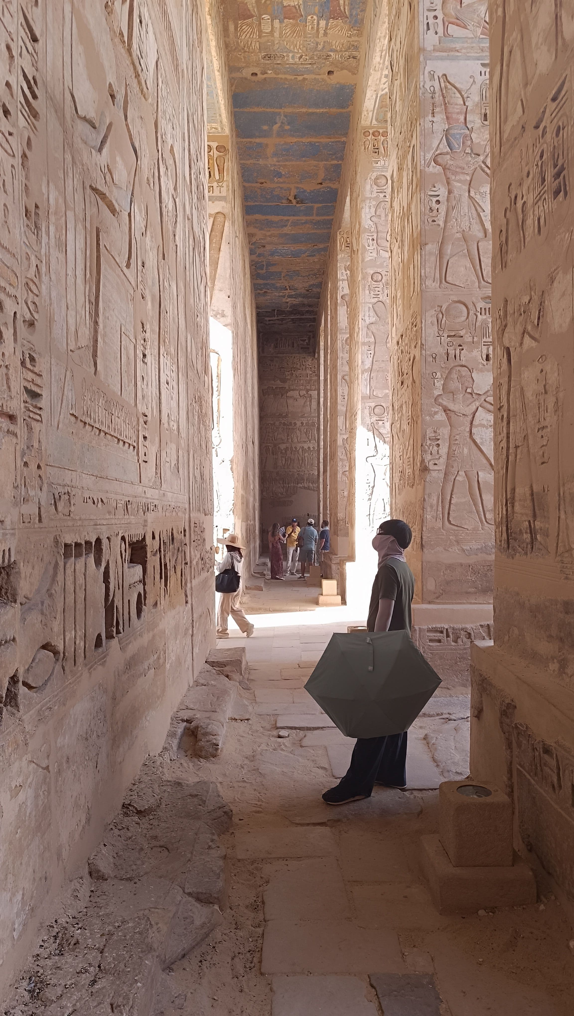 Colonnade walls carved end to end with hieroglyphs.